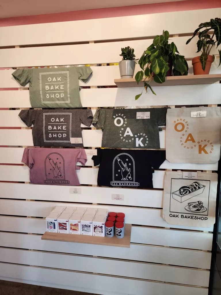 Rhode Island's Oak Bakeshop clothing and merchandise line hung up on their bakery walls.