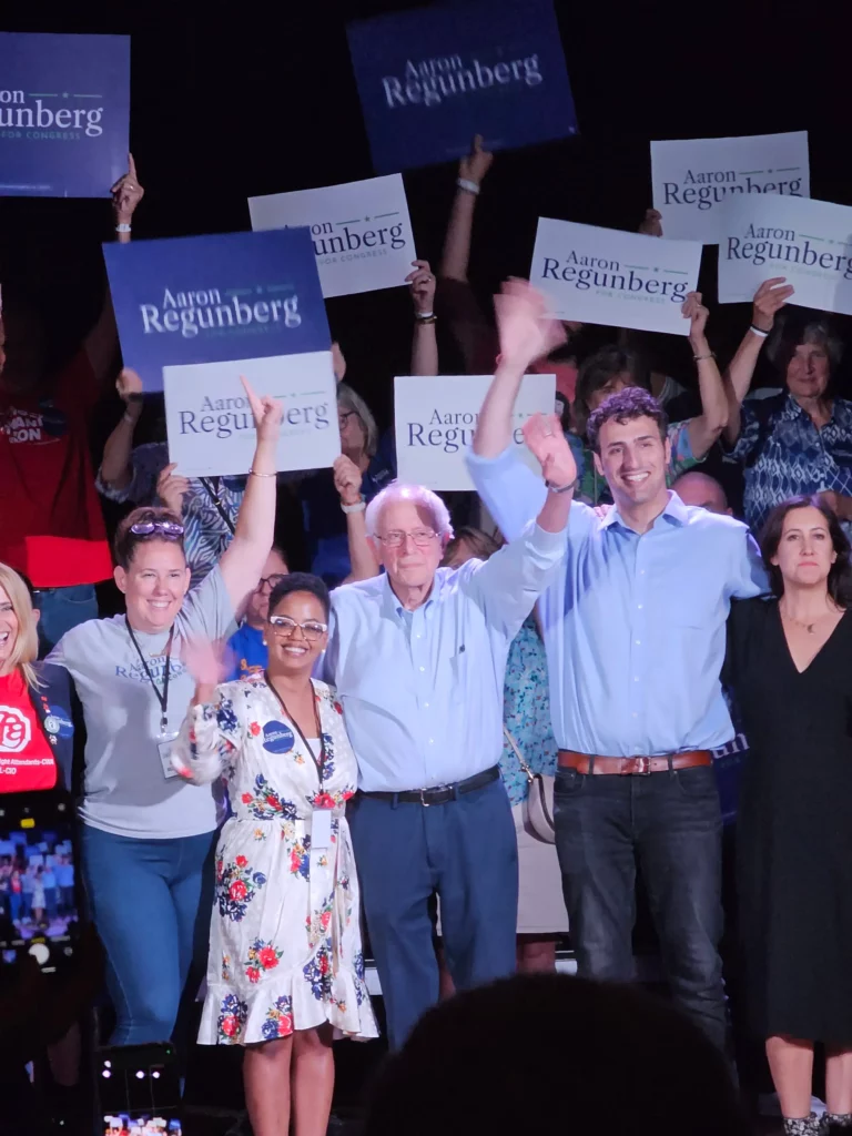 Bernie Sanders with Rhode Island's Aaron Regunberg and family on stage at the 2023 Special Election rally.