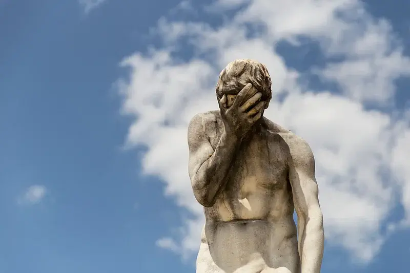 A stone statue facepalming.
