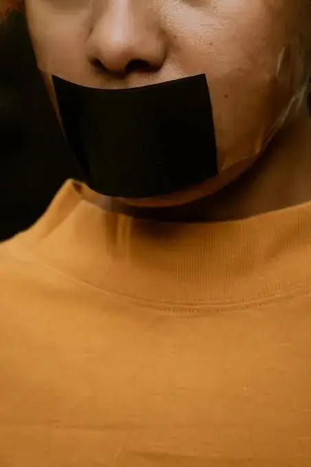 Person with tape over mouth.